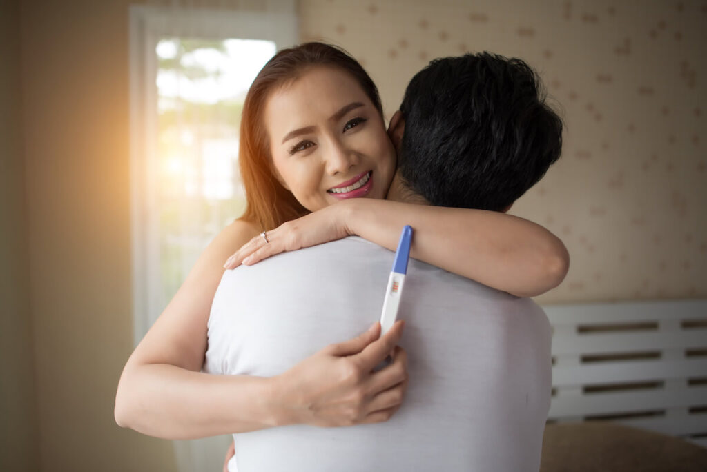 happy-couple-smiling-after-find-out-positive-pregnancy-test-compressed