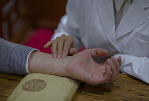 female-chinese-doctor-taking-the-pulse-of-patient